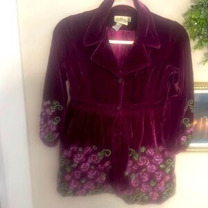 Plum velvet girls jacket with embroidered roses along sleeves and front.